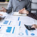 business-team-analyzing-financial-documents-and-us-2025-10-27-19-19-00-utc